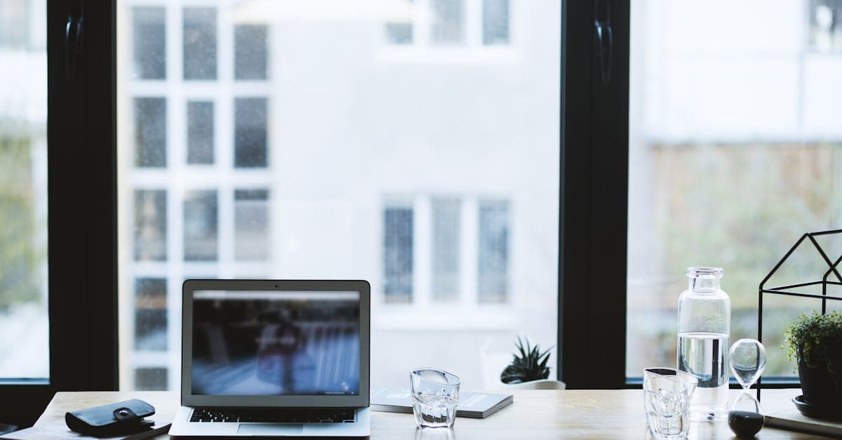 Laptop on a desk by a window with a travel view